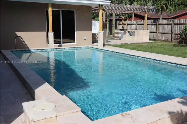 a view of deck with table and chairs