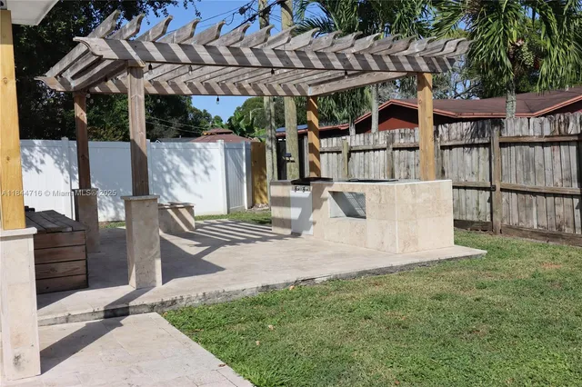 a backyard of a house with a basket ball court
