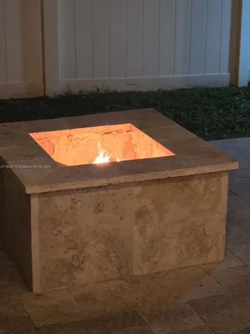 a view of a house with backyard and a tree