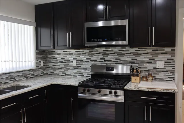 a kitchen with a stove and a microwave