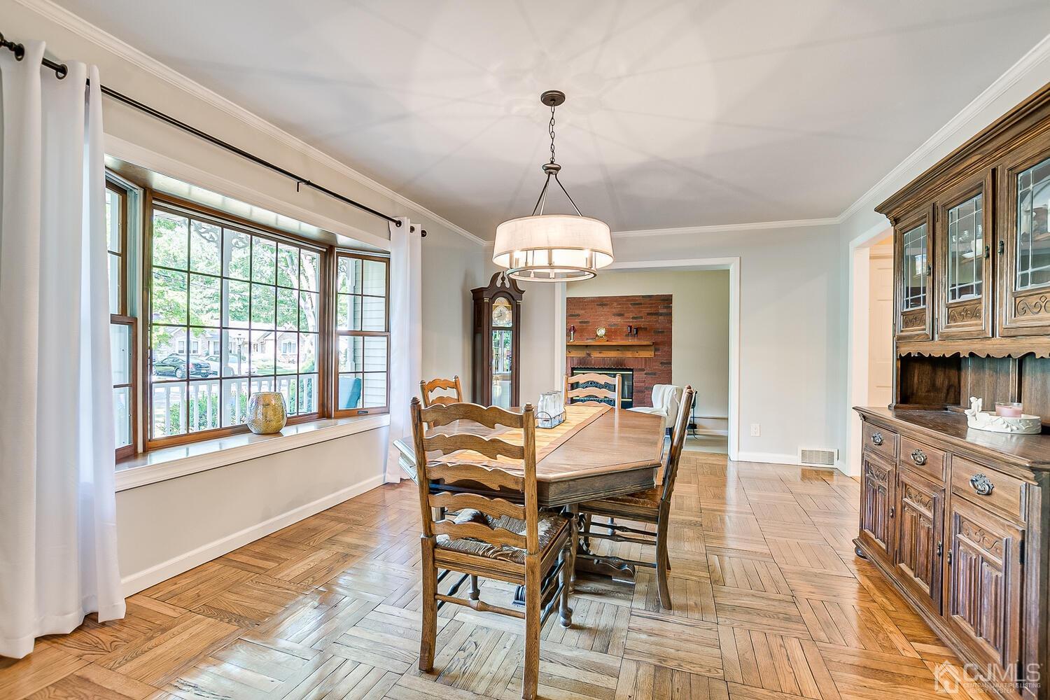 27 Homestead Road Edison, NJ 08820 - Photo 17 of 64 a dining room with furniture a chandelier and wooden floor