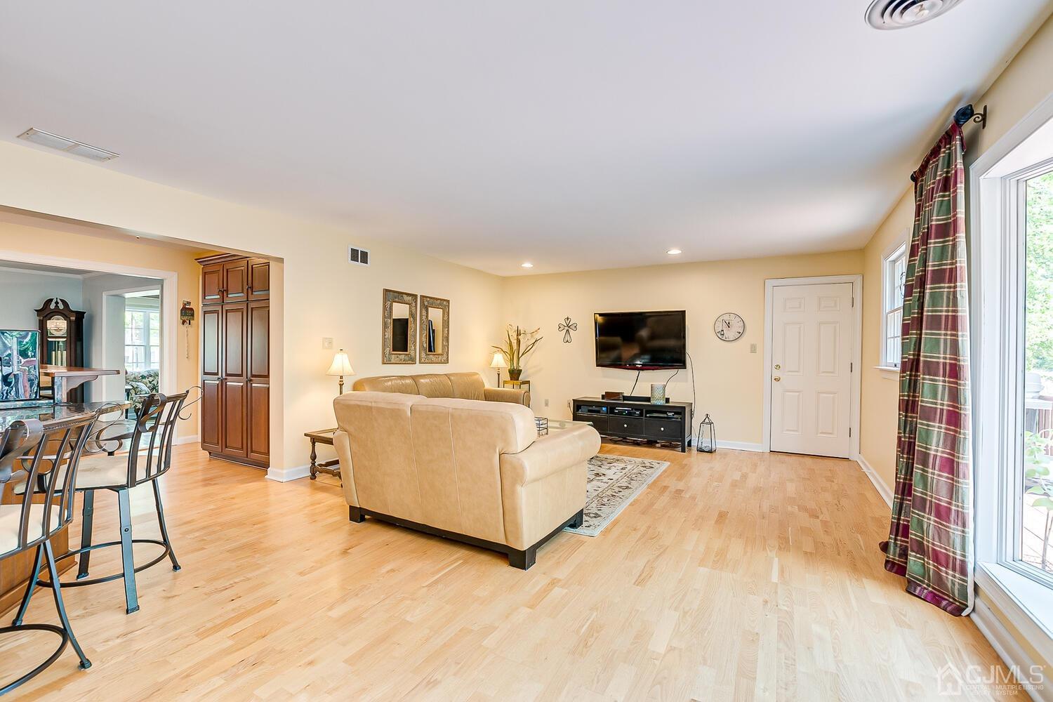 27 Homestead Road Edison, NJ 08820 - Photo 28 of 64 a living room with furniture a flat screen tv and a refrigerator