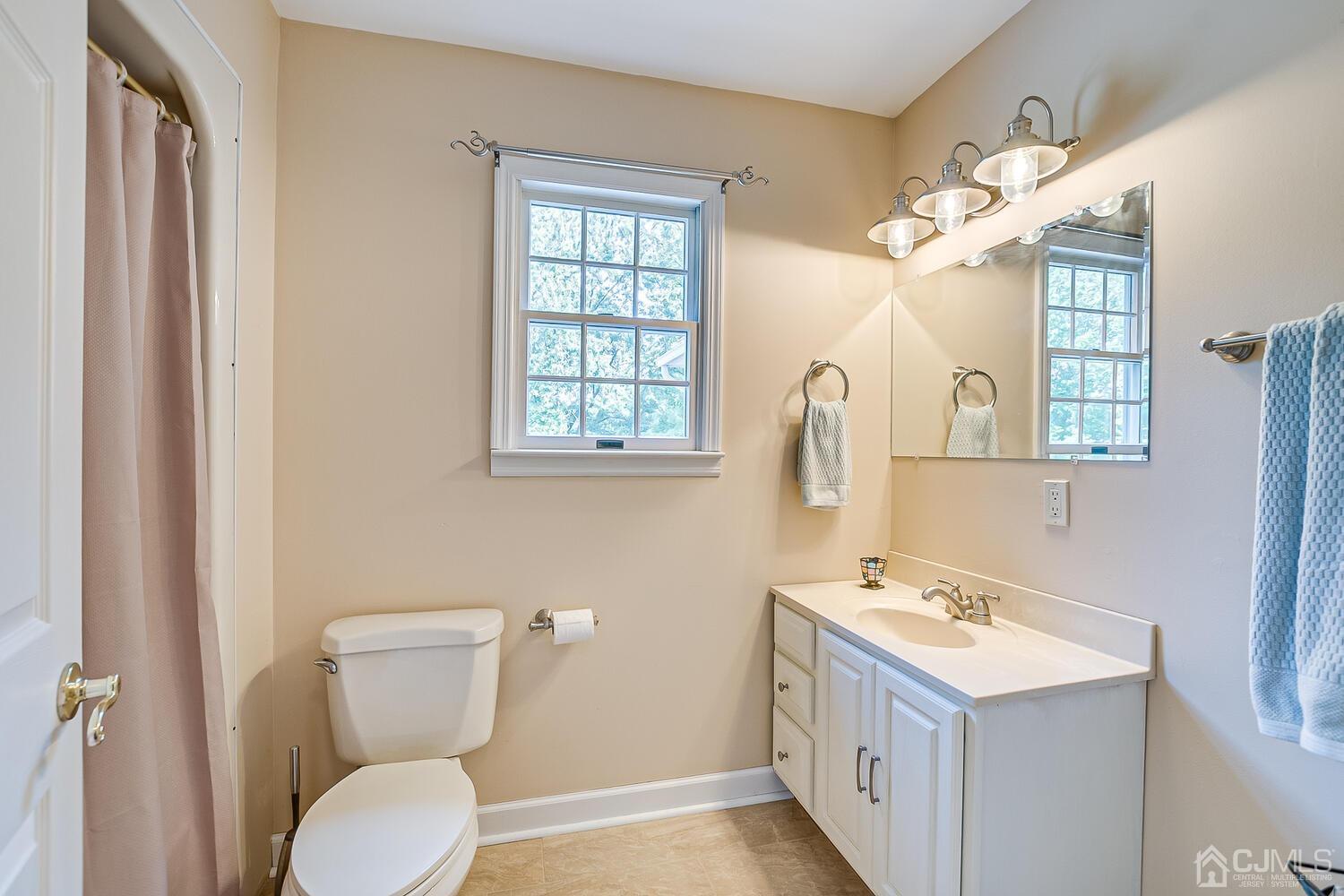 27 Homestead Road Edison, NJ 08820 - Photo 44 of 64 a bathroom with a sink a toilet and mirror