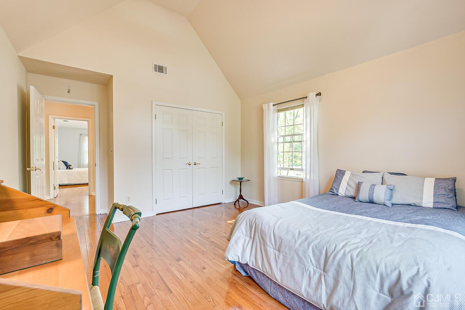 27 Homestead Road Edison, NJ 08820 - Photo 48 of 64 a bedroom with a bed and a large mirror