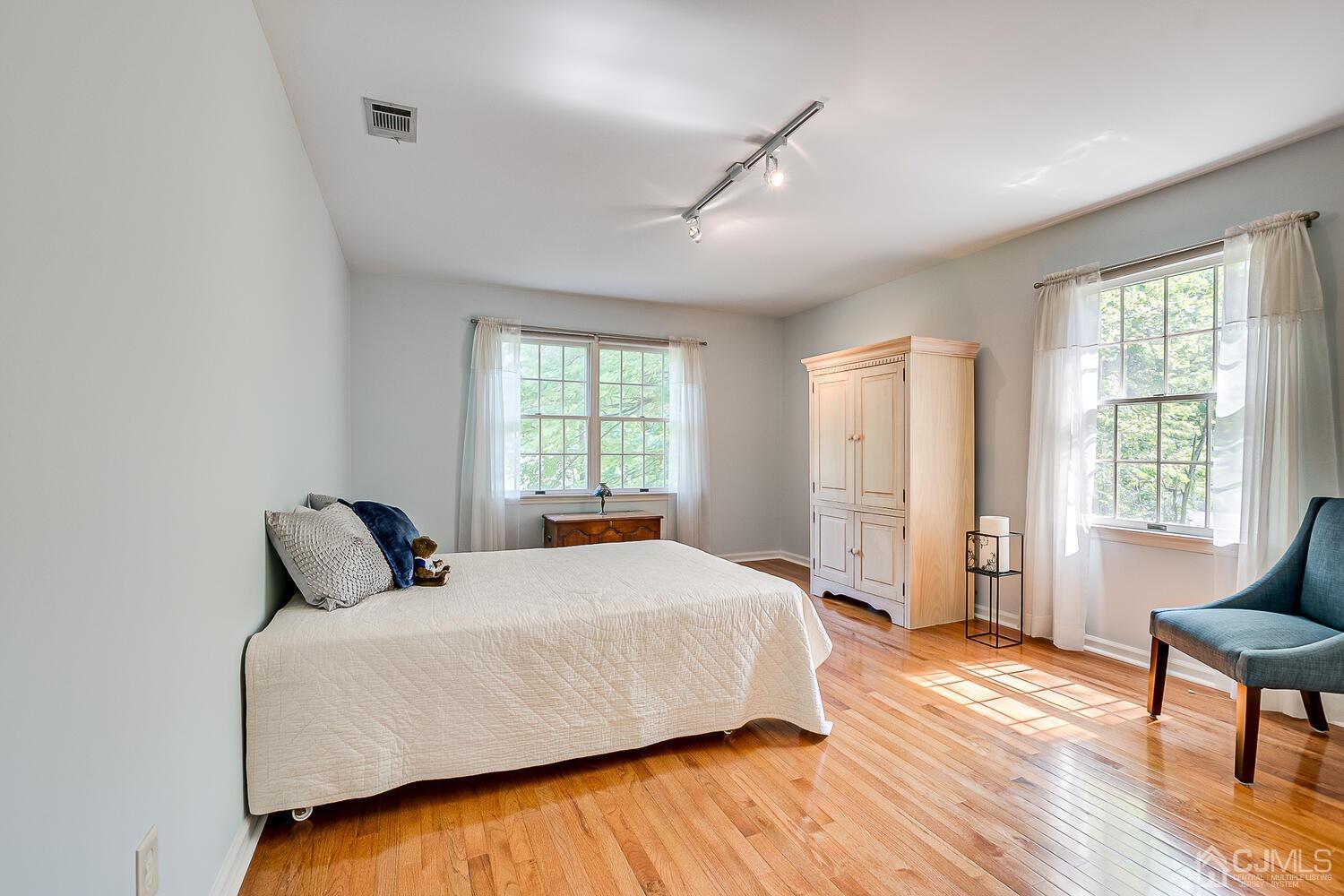 27 Homestead Road Edison, NJ 08820 - Photo 49 of 64 a bedroom with a bed and wooden floor