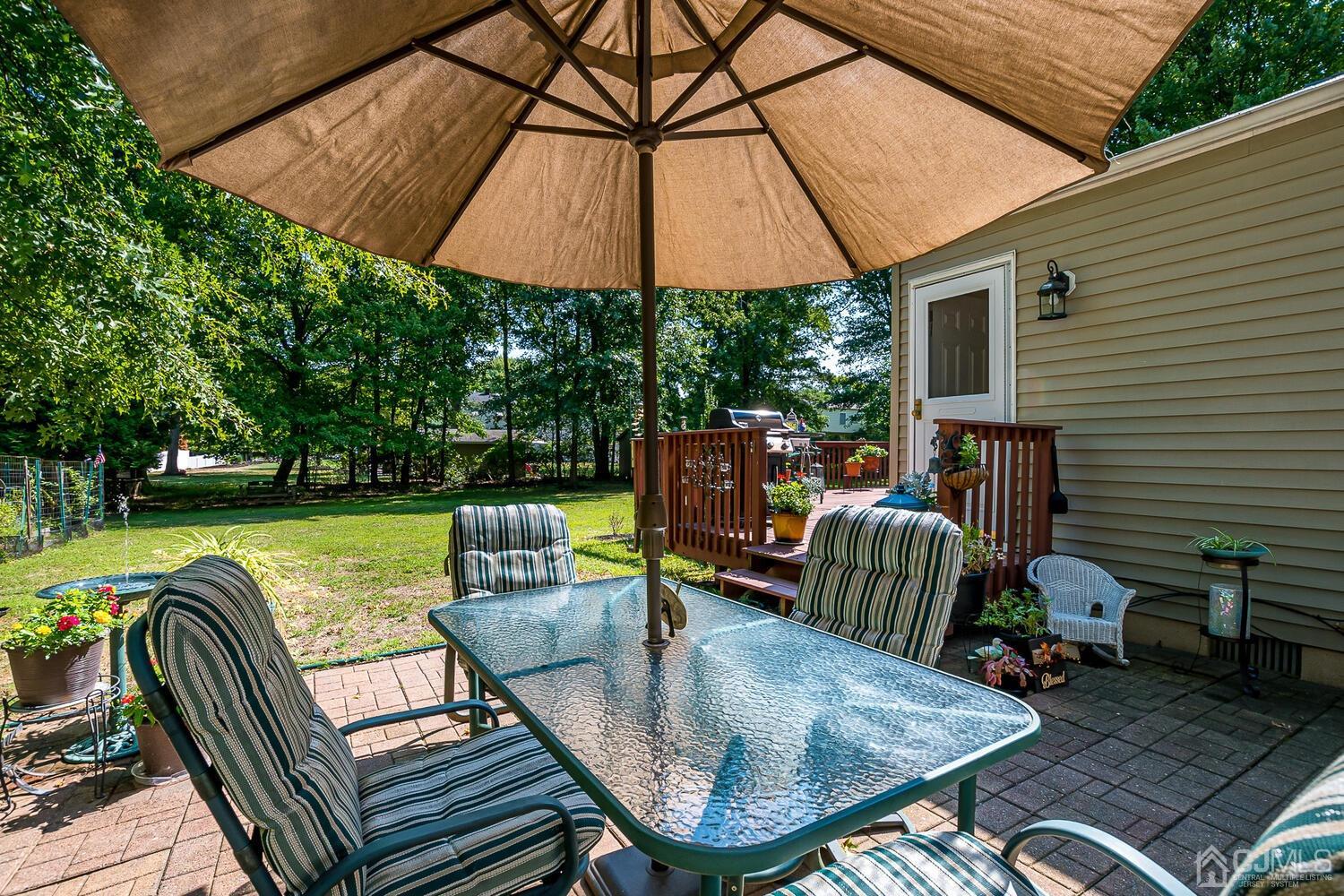 27 Homestead Road Edison, NJ 08820 - Photo 55 of 64 a patio with a patio table and chairs