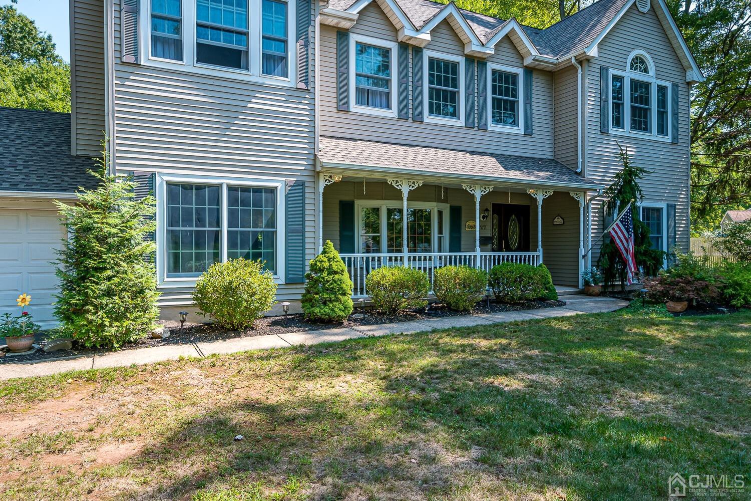 27 Homestead Road Edison, NJ 08820 - Photo 10 of 64 a view of a brick house with many windows plants and large tree
