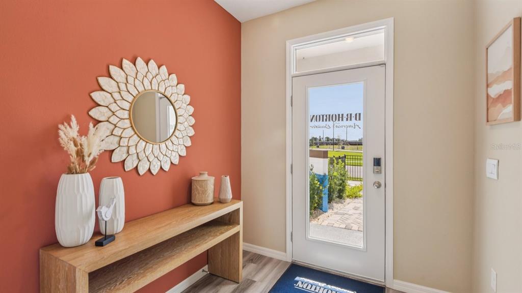 32502 Welling Blade Loop Wesley Chapel, FL 33545 - Photo 17 of 42 a room with a table and a potted plant