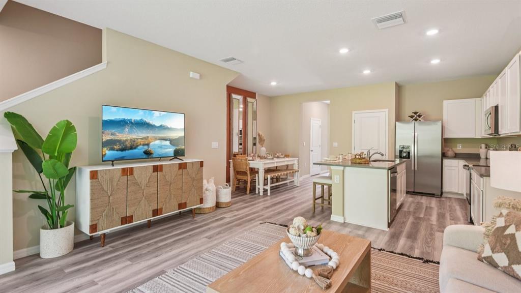 32502 Welling Blade Loop Wesley Chapel, FL 33545 - Photo 9 of 42 a living room with furniture a potted plant and kitchen view