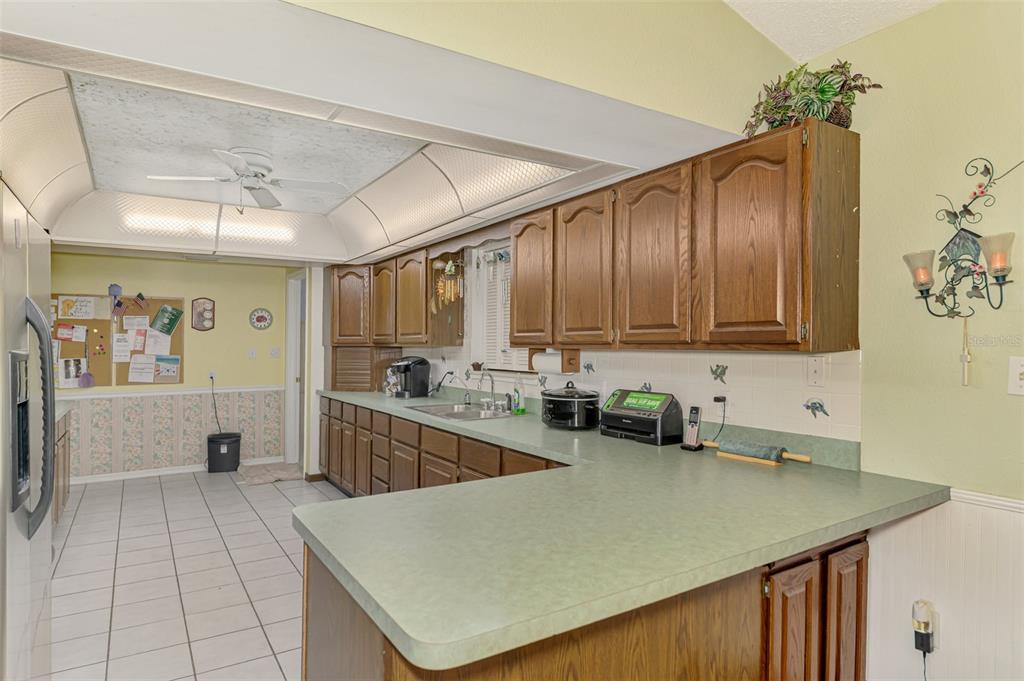 1137 Ponderosa Road Venice, FL 34293 - Photo 15 of 48 a kitchen with a sink a stove cabinets and a counter top space