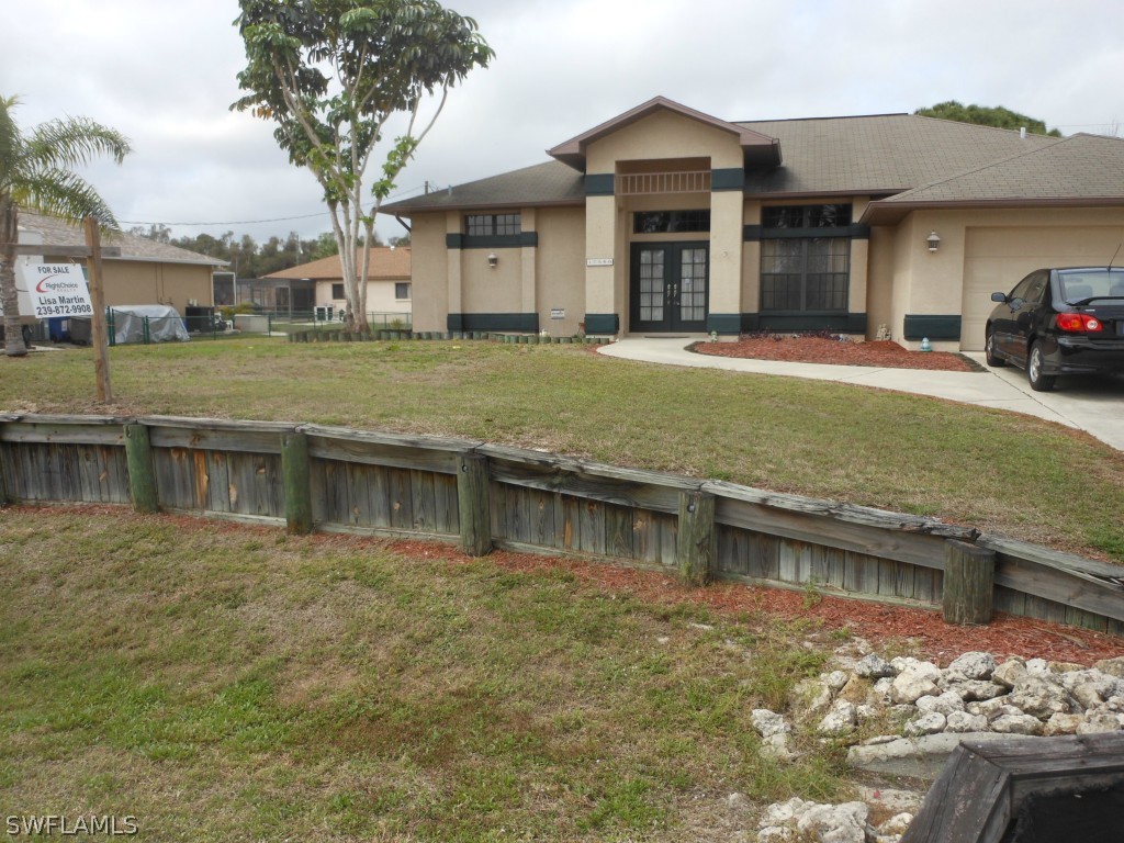 17560 Homewood Road Fort Myers, FL 33967 - Photo 1 of 9 a front view of a house with garden
