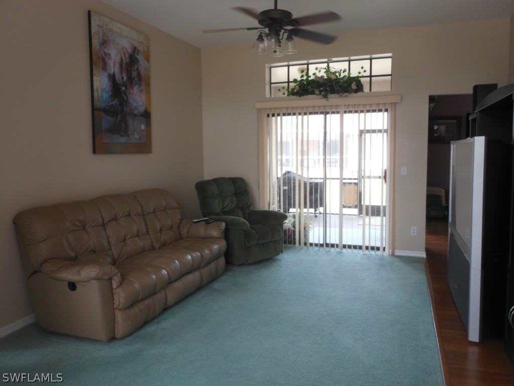 17560 Homewood Road Fort Myers, FL 33967 - Photo 3 of 9 a living room with furniture and a flat screen tv