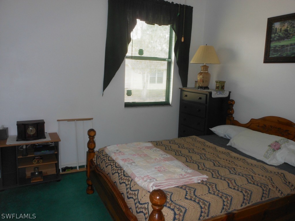 17560 Homewood Road Fort Myers, FL 33967 - Photo 9 of 9 a bedroom with a bed and a tv on the dresser