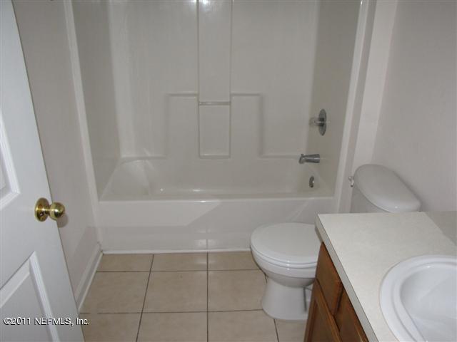 7920 Merrill Road, Unit 1816 Jacksonville, FL 32277 - Photo 8 of 10 a bathroom with a toilet and a shower