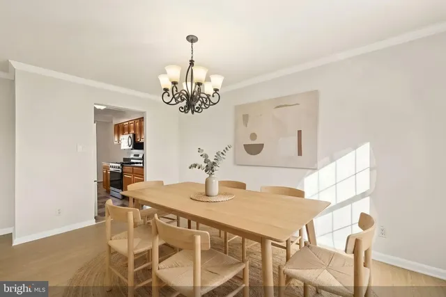 a view of a dining room with furniture and chandelier