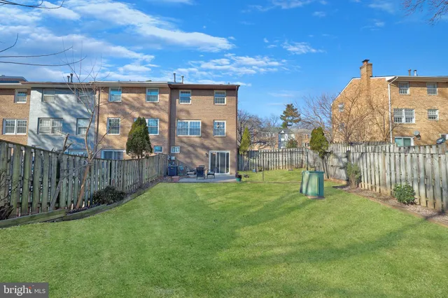 a view of a garden with a building in the background