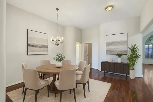 a dining room with furniture a window and wooden floor
