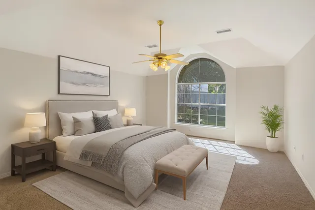 a bedroom with a bed and a window