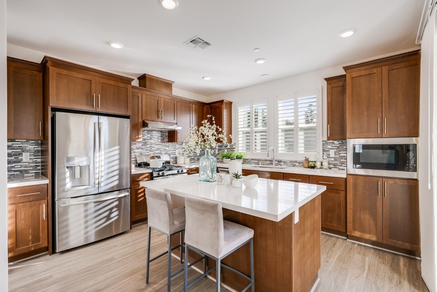 39478 Capstone Common Fremont, CA 94539 - Photo 4 of 33 a kitchen with granite countertop a center island stainless steel appliances cabinets and a large window