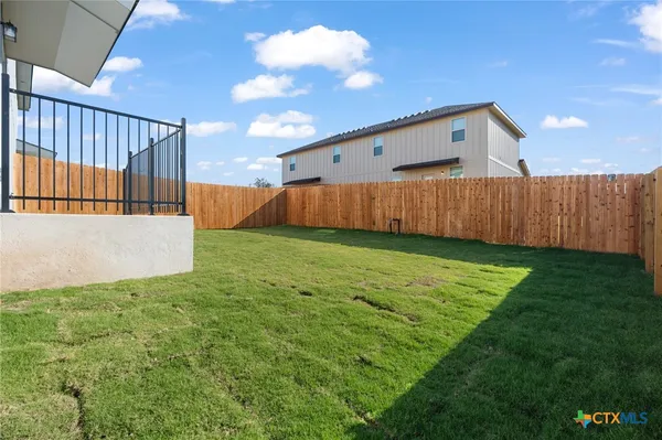a view of a backyard with pathway