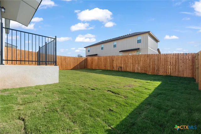 a view of a backyard with pathway