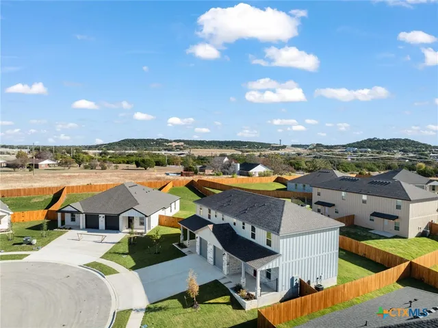 an aerial view of residential houses with outdoor space