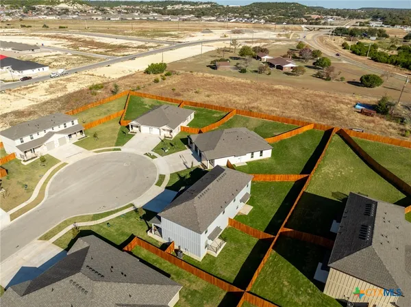 an aerial view of residential houses with outdoor space