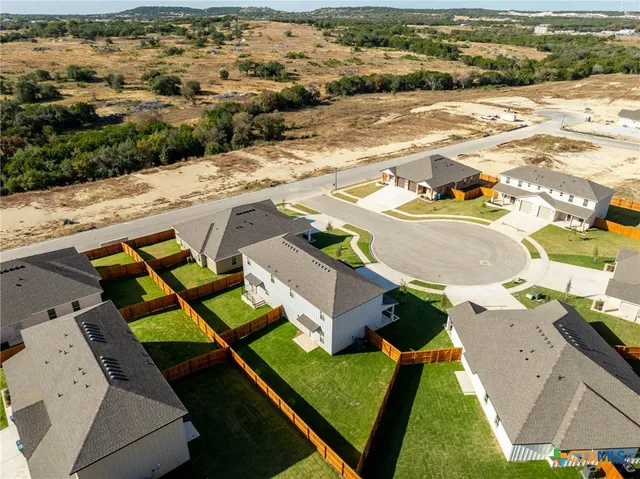 an aerial view of residential houses with outdoor space