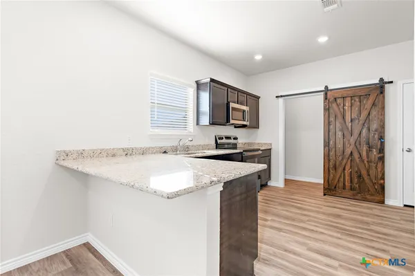 a kitchen with a sink a stove and a refrigerator