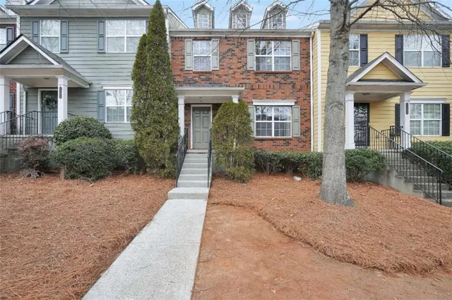 a view of a brick house with many windows