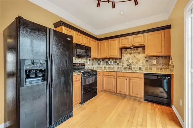 a kitchen with a refrigerator and a stove top oven