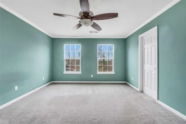 a view of room with window and ceiling fan