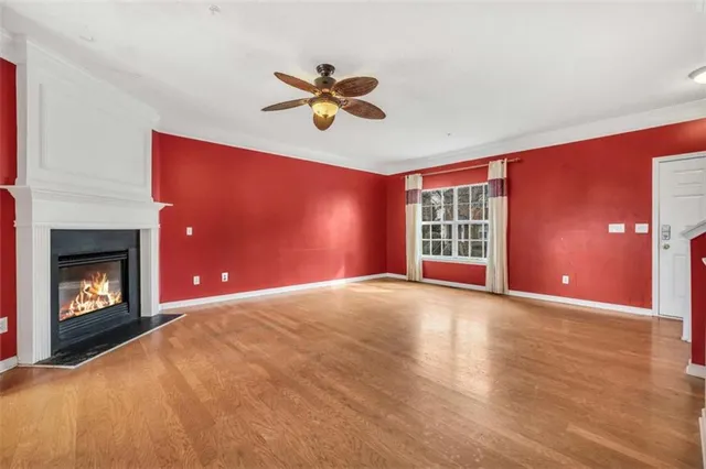 a view of an empty room with a window and fireplace