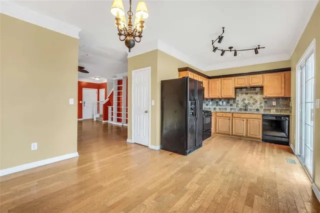 a view of a kitchen with a refrigerator and a stove top oven