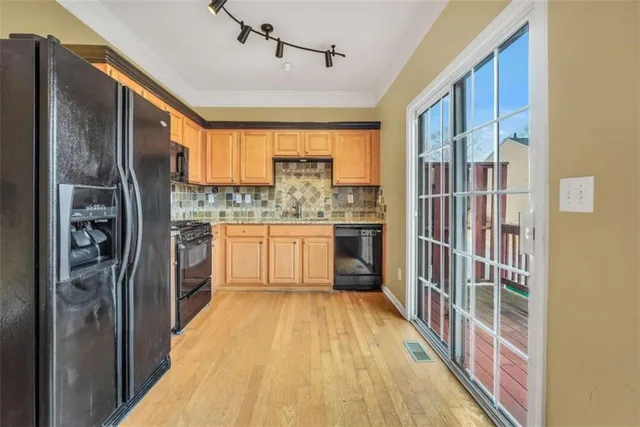 a kitchen with kitchen island a counter top space a sink and stainless steel appliances