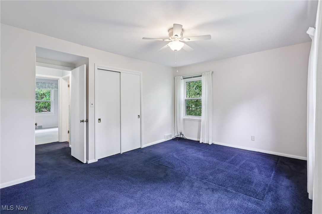 33300 South Woodland Road Cleveland, OH 44124 - Photo 33 of 50 Unfurnished bedroom featuring dark carpet, a closet, and ceiling fan