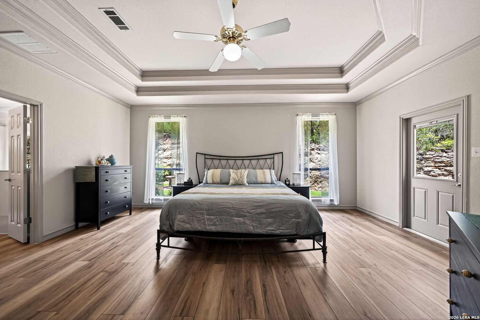 17431 Helotes Spring Road Helotes, TX 78023 - Photo 24 of 50 a bedroom with a bed and wooden floor
