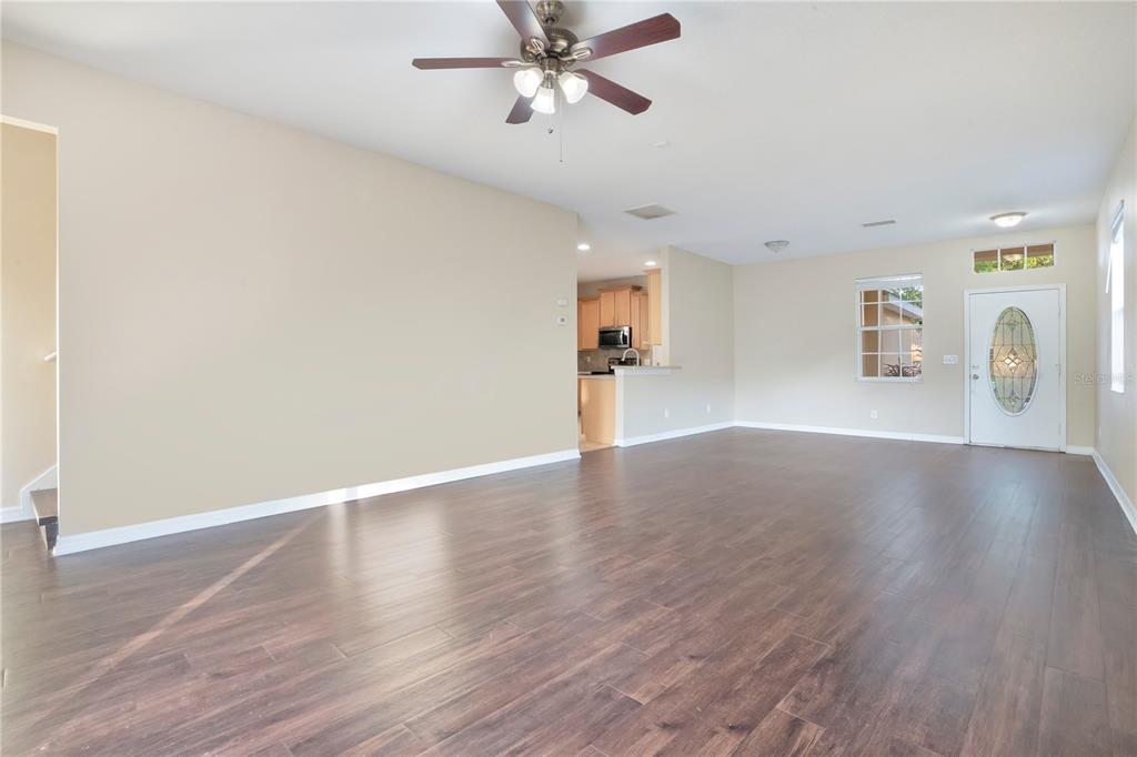 15031 Skip Jack Loop Lakewood Ranch, FL 34202 - Photo 6 of 27 a view of an empty room with window and wooden floor