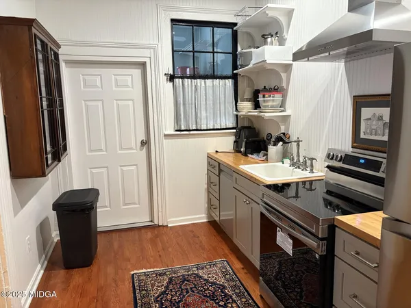 a kitchen with granite countertop a stove and a refrigerator