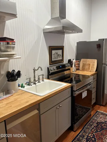 a kitchen with sink stove and cabinets