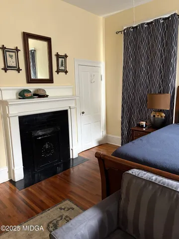 a bedroom with a bed and a fireplace