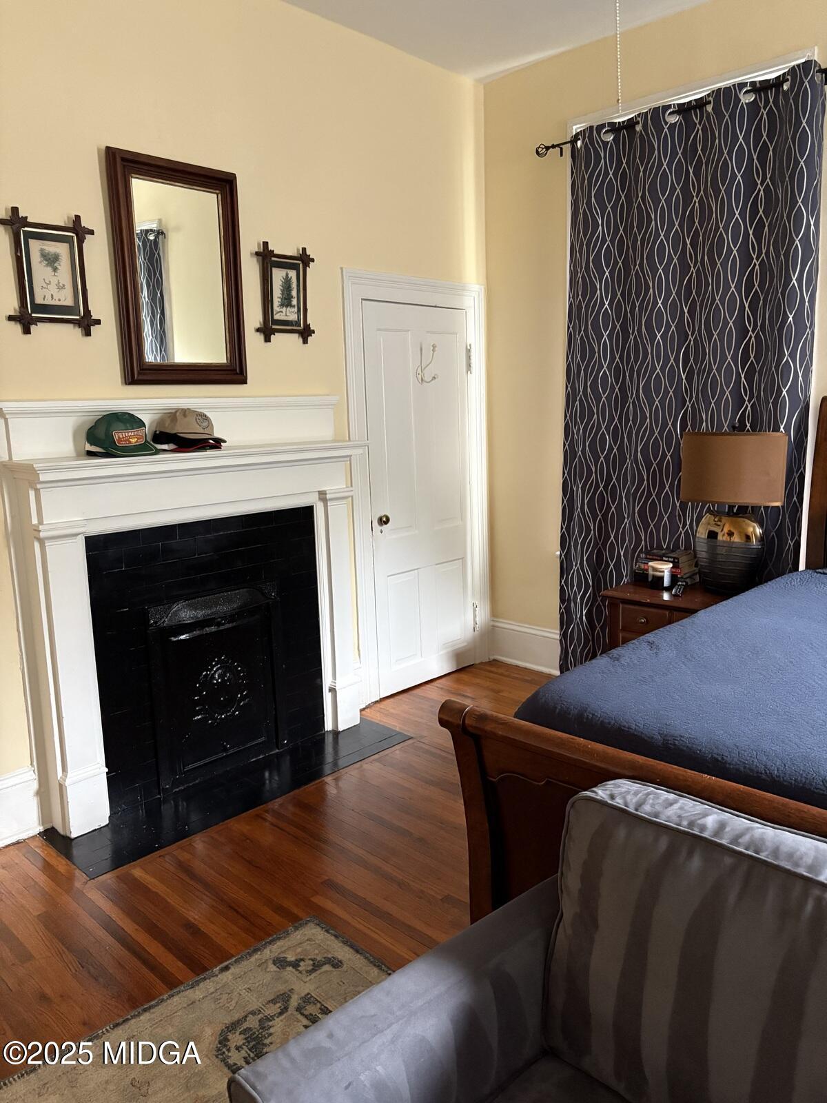 312 College Street, Unit 3 Macon, GA 31201 - Photo 17 of 24 a bedroom with a bed and a fireplace