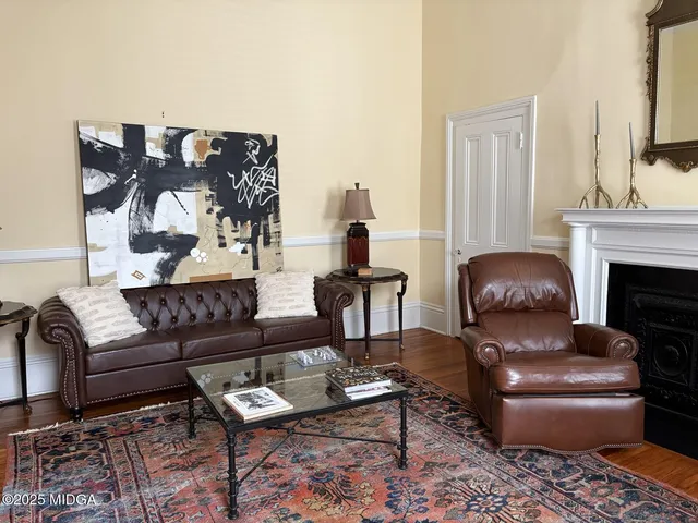 a living room with furniture and a fireplace