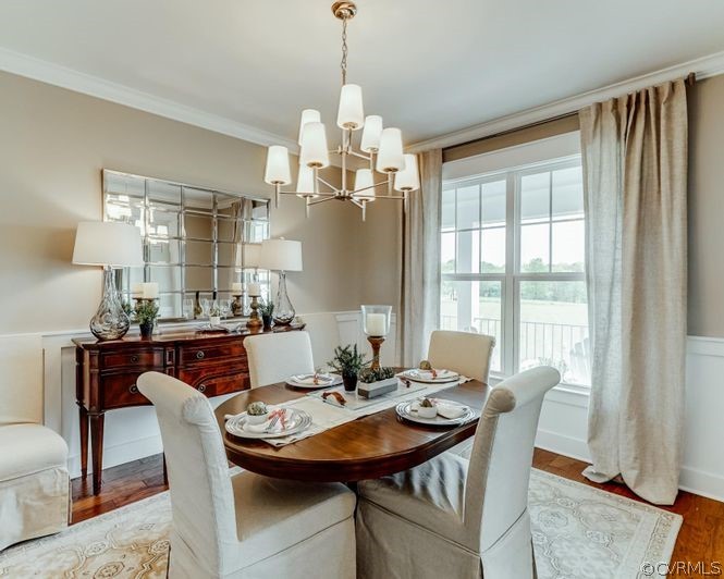 9112 Copplestone Road Chesterfield, VA 23832 - Photo 3 of 20 a dining room with furniture a chandelier and wooden floor