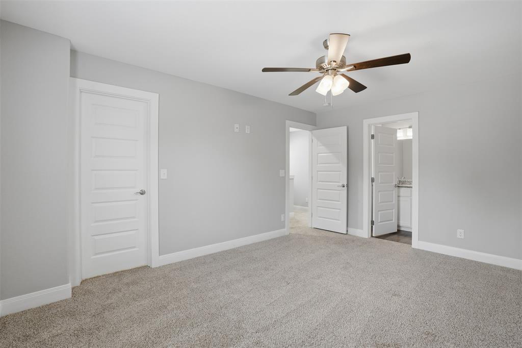 1022 West Shepherd Street, Unit 1022 Denison, TX 75020 - Photo 13 of 27 a view of an empty room and window ceiling fan