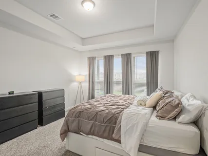 a bedroom with a bed and window