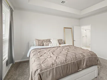 a bedroom with a bed and window