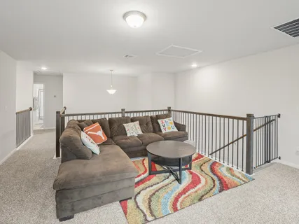 a living room with furniture and a rug