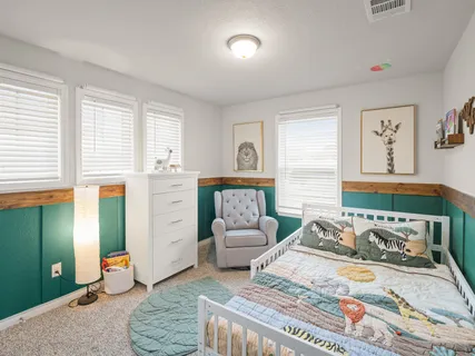 a bedroom with furniture and a window