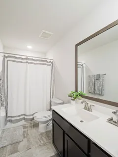 a bathroom with a double vanity sink toilet and a mirror